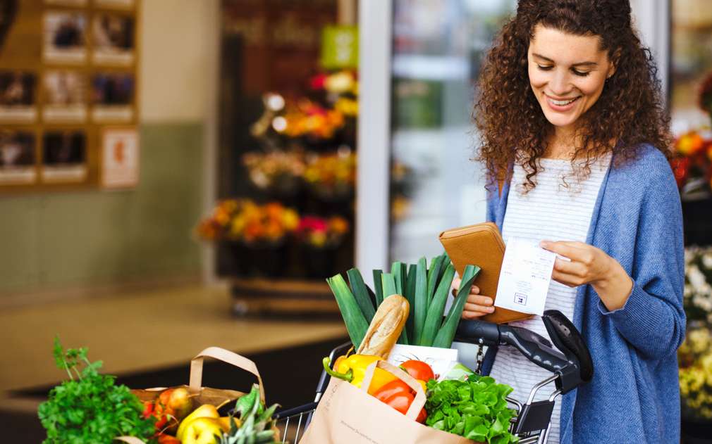 Пазарувай и печели с Kaufland Изображение да жена, коята разглежда касовия си бон